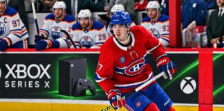 Kirby Dach of the Montreal Canadiens skates past Edmonton Oilers players as NHL trade rumors link Dach to a possible Oilers trade.