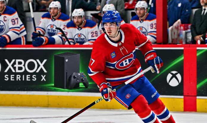 kirby-dach-edmonton-oilers-montreal-canadiens-trade-rumors (1) Kirby Dach of the Montreal Canadiens skates past Edmonton Oilers players as NHL trade rumors link Dach to a possible Oilers trade.