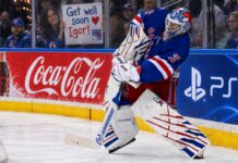 NHL News Today: Shesterkin Out for Season, Canadiens Trade Struble, Edvinsson Rumors Heat Up New York Rangers goalie Igor Shesterkin in action as a female Rangers fan holds a "Get well soon Igor!" sign behind the glass, following his season-ending injury. Coca-Cola and PS5 advertisements line the boards.