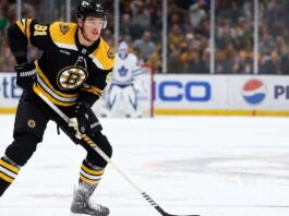 Boston Bruins defenceman Nikita Zadorov skates with the puck against the Toronto Maple Leafs amid NHL trade rumors sparked by comments from his agent, Dan Milstein.
