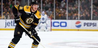 Boston Bruins defenceman Nikita Zadorov skates with the puck against the Toronto Maple Leafs amid NHL trade rumors sparked by comments from his agent, Dan Milstein.