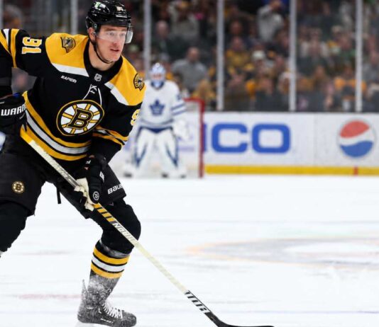Boston Bruins defenceman Nikita Zadorov skates with the puck against the Toronto Maple Leafs amid NHL trade rumors sparked by comments from his agent, Dan Milstein.