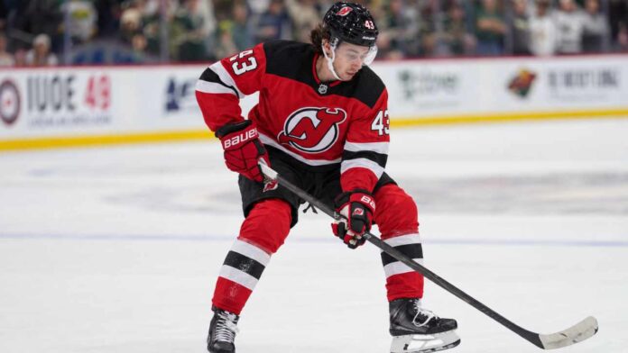 quinn-hughes-devils-trade-rumors-connor-hellebuyck Quinn Hughes pictured in a New Jersey Devils home jersey as NHL trade rumors link the Minnesota Wild defenseman to New Jersey following the Connor Hellebuyck blockbuster trade.