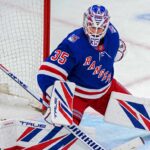 Rangers Trade Rumors: Did Montreal Just Make Sam Montembeault Expendable? Sam Montembeault wearing a New York Rangers home jersey and goalie equipment in a mock trade image highlighting NHL trade rumors involving the Montreal Canadiens.