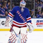Vancouver Canucks vs. New York Rangers Fantasy Hockey Prediction: Players to Watch, Score Pick & How to Watch New York Rangers goalie Igor Shesterkin in front of his net with Gatorade and Super Chexx Bubble Hockey board ads and Canucks and Rangers fans in the stands.