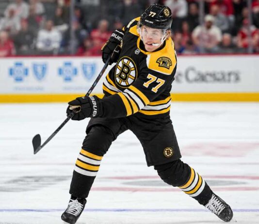 Simon Edvinsson wearing a Boston Bruins home jersey and helmet in a hypothetical uniform swap as NHL trade rumors link the Bruins to the Detroit Red Wings defenseman.