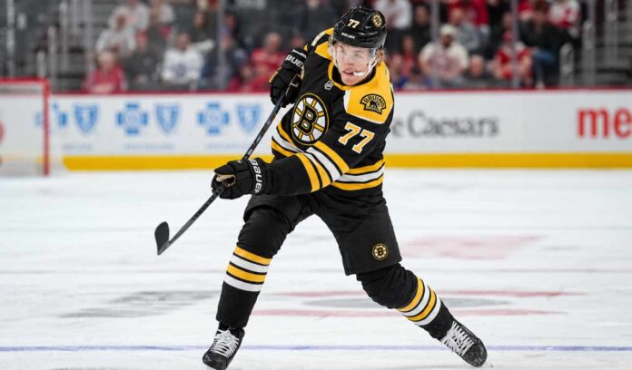 simon-edvinsson-detroit-red-wings-boston-bruins-trade-rumors Simon Edvinsson wearing a Boston Bruins home jersey and helmet in a hypothetical uniform swap as NHL trade rumors link the Bruins to the Detroit Red Wings defenseman.