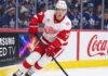 Simon Edvinsson Trade Rumors: Are Teams Testing the Detroit Red Wings? Simon Edvinsson skates for the Detroit Red Wings in front of Toronto Maple Leafs fans amid NHL trade rumors and contract uncertainty.