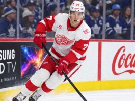 Simon Edvinsson skates for the Detroit Red Wings in front of Toronto Maple Leafs fans amid NHL trade rumors and contract uncertainty.