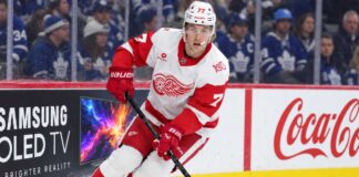Simon Edvinsson skates for the Detroit Red Wings in front of Toronto Maple Leafs fans amid NHL trade rumors and contract uncertainty.