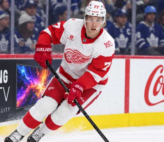 Simon Edvinsson skates for the Detroit Red Wings in front of Toronto Maple Leafs fans amid NHL trade rumors and contract uncertainty.