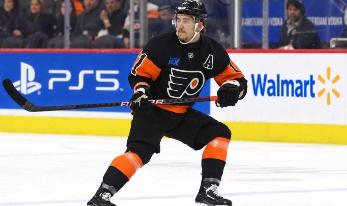 travis-konecny-philadelphia-flyers-trade-rumors-2026 Travis Konecny wearing his Philadelphia Flyers home jersey during an NHL game as trade rumors intensify following the Flyers' historic winless start to the 2026-27 season.