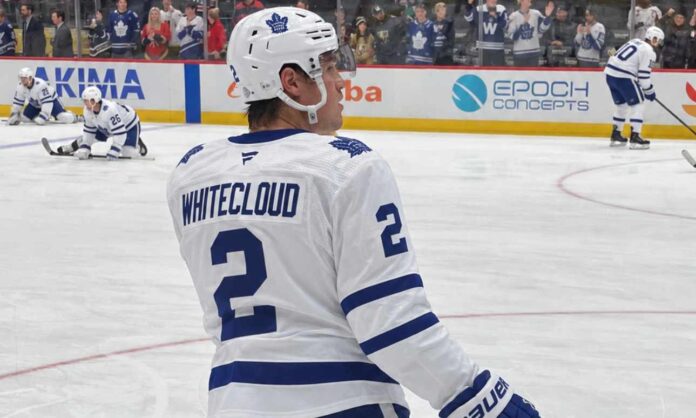 zach-whitecloud-toronto-maple-leafs-trade-rumors Zach Whitecloud pictured in a Toronto Maple Leafs white away jersey in a trade rumor photo illustration, as Toronto explores defensive upgrades involving the Calgary Flames blueliner.